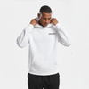 Sweat à capuche blanc pour homme, modèle "Briefing Blanc" de la marque Tourismo Clothing. Hoodie sans cordon avec poche kangourou, capuche structurée tenue par les deux mains du mannequin. Logo noir brodé "TOURISMO" accompagné d’un motif damier, positionné sur la poitrine côté gauche. Plan cadré buste, regard du mannequin dirigé vers le bas, expression concentrée. Fond studio blanc, lumière neutre. Vêtement streetwear inspiré de l’univers racing, entre élégance minimaliste et tension d’avant-course.