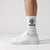 Calzini Need Money For Porsche bianco, indossati, vista laterale con sneakers bianche