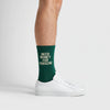 Calzini Need Money For Porsche verde bottiglia, indossati, vista laterale con sneakers bianche