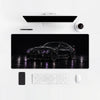 Tappetino mouse BMW M4 luci viola, su una scrivania chiara con computer, tastiera e mouse